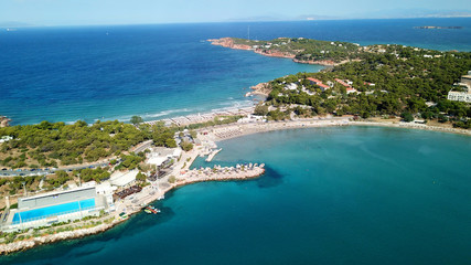 Fototapeta na wymiar Aerial drone bird's eye photo of famous marina of Vouliagmeni with luxury yachts docked in south Athens riviera Peninsula with turquoise clear waters, Greece