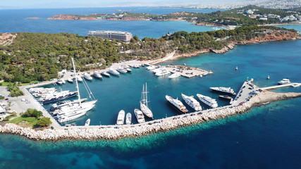 Aerial drone bird's eye photo of famous marina of Vouliagmeni with luxury yachts docked in south Athens riviera Peninsula with turquoise clear waters, Greece