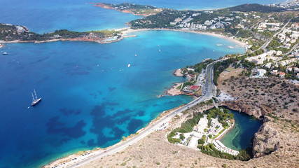Obraz premium Aerial drone, bird's eye photo from iconic lake Vouliagmeni famous for healing abilities and Ateras Peninsula at the background, Athens riviera, Attica, Greece