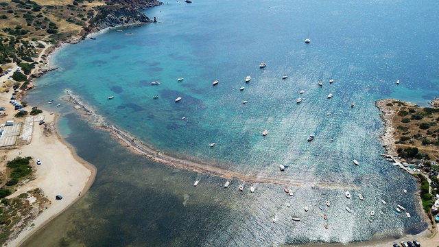 Aerial drone bird's eye view of iconic beach and small islet of Agios Nikolaos, Anavysos, Athens Riviera, Attica, Greece