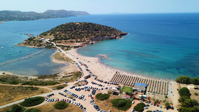 Aerial drone bird's eye view of iconic beach and small islet of Agios Nikolaos, Anavysos, Athens Riviera, Attica, Greece