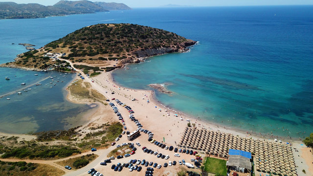 Aerial drone bird's eye view of iconic beach and small islet of Agios Nikolaos, Anavysos, Athens Riviera, Attica, Greece
