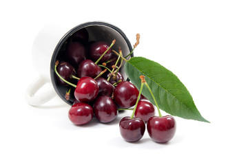 White cup with red sweet cherry isolated on a white background..