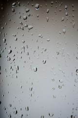 Rain drops or condensation on the glass. It is a cold autumn or winter