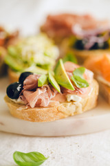 Tapas sandwich snack with ham on table. Closeup