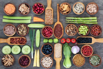 Healthy super food for fitness concept with legumes,fresh vegetables and fruit, & spices. High in omega 3 fatty acids, antioxidants, anthocyanins, vitamins & minerals.