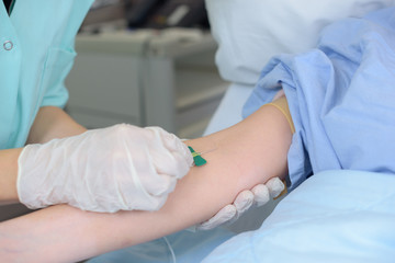 Needle being inserted into patient's arm