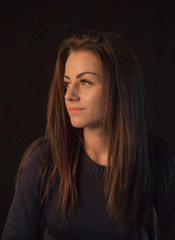 Studio portrait of young beautiful woman posing on black background