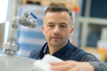brewmaster expert checks the quality of the freshly tapped beer