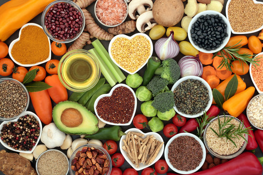 Food for good health and fitness concept with fruit, vegetables, pulses, grains, herbs, spices, nuts, seeds, olive oil & himalayan salt.  High in antioxidants, smart carbohydrates & anthocyanins.  