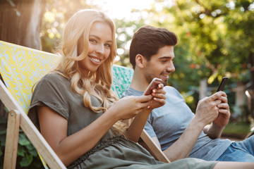 Side view of Happy lovely young couple sitting together