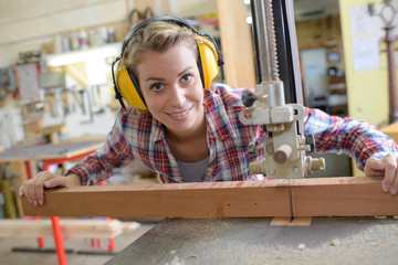 smiling female carpenter in her workshop