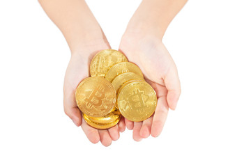 Children's hands holding golden Bitcoin