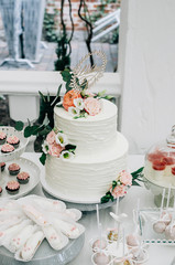 Two-tier cake on a sweets table at a wedding