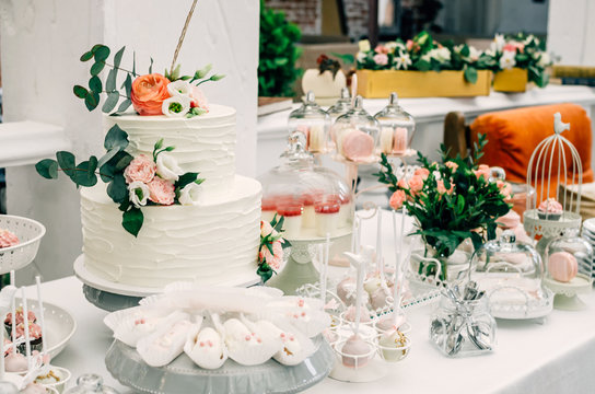 Two-tier cake on a sweets table at a wedding