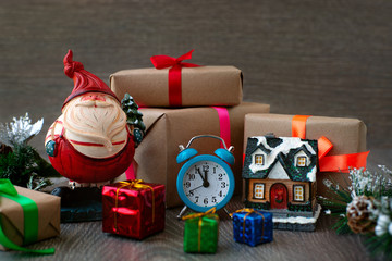 Pot-bellied Santa claus and clock for the new year. Many gifts, a clock, a fairy-tale house and a...