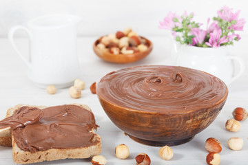 Homemade hazelnut spread in wooden bowl with toast bowl for breakfast. Hazelnut Nougat cream. Nutella cream.