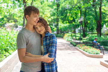 Young man huging a girl in the park.