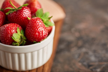 Fresh red strawberry on a dark abstract background. Summer berries. The concept of healthy eating.