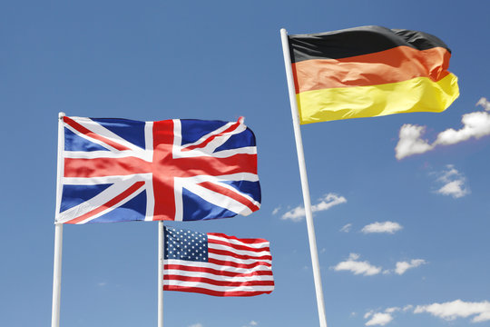 USA. Arizona. Flags of the United Kingdom, USA and Germany floating in the sky.