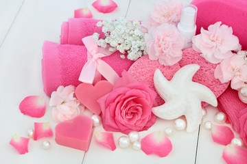 Beauty treatment cleansing products with pink rose and carnation flowers, heart and shell shaped...