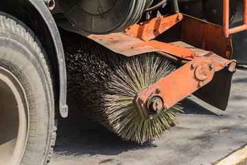 close up of street cleaning sweeper machine washes the asphalt road