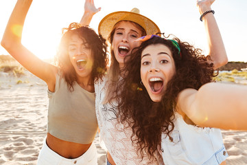 Three joyful girls friends in summer clothes