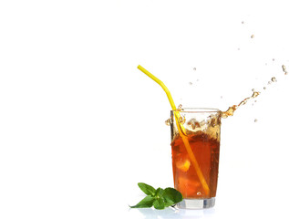Splashes from a glass of cold tea with lemon.