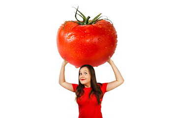 Cute funny young girl holds over herself huge red tomato with drops water , isolated on a white background