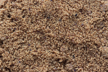 Top view flat lay of natural brown sugar or unrefined sugar with close up view and copy space to show texture. Sweet seasoning for good health. Ingredient prepared for cooking or bakery and beverage..
