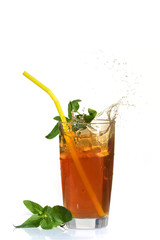 Splashes of iced tea from lemon slice on white isolated background.