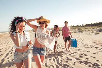 Group of happy young friends in summer clothes