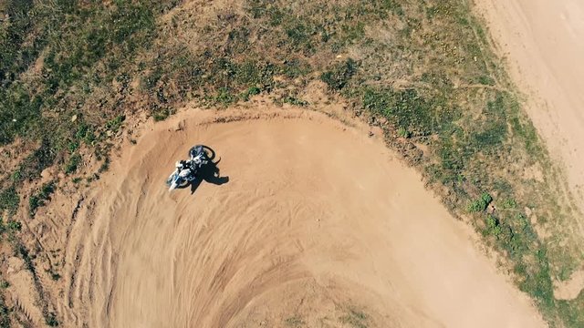 A motorbike rider on a track, top view.