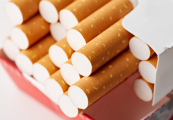 cigarettes in a pack close-up on a white background. Drug addiction. Smoking of tobacco. cancer....