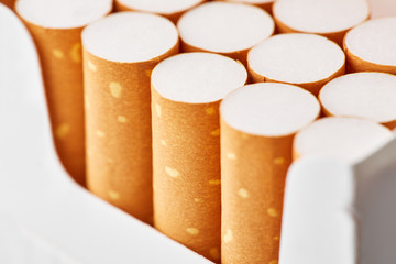 cigarettes in a pack close-up on a white background. Drug addiction. Smoking of tobacco. cancer....