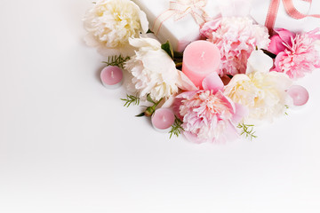 Festive flowers pink and white peony, gift, ribbon, candles composition on the white background. Overhead top view, flat lay. Copy space. Birthday, Mother's, Valentines, Women's, Wedding Day concept