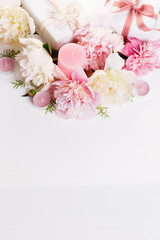 Obraz na płótnie Canvas Festive flowers pink and white peony, gift, ribbon, candles composition on the white background. Overhead top view, flat lay. Copy space. Birthday, Mother's, Valentines, Women's, Wedding Day concept