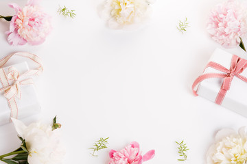 Festive flowers pink and white peony, gift with ribbon composition on the white background. Overhead top view, flat lay. Copy space. Birthday, Mother's, Valentines, Women's, Wedding Day concept.