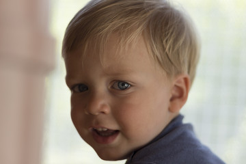 Image of cute baby boy, closeup portrait of adorable child on blurred background, sweet toddler with blue eyes, healthy childhood, perfect caucasian infant, lovely kid, innocence concept