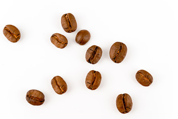 close up of medium or dark roasted coffee beans isolated on white background, can be used as a background or graphic object in your ads.