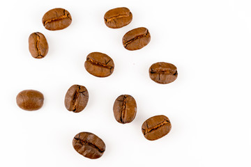 close up of medium or dark roasted coffee beans isolated on white background, can be used as a background or graphic object in your ads.