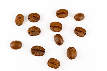 close up of medium or dark roasted coffee beans isolated on white background, can be used as a background or graphic object in your ads.