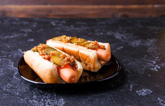 Image of hotdogs on black plate