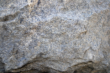 Gray natural stone texture, relief granite surface, may be used as background