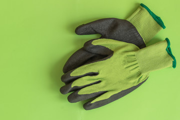 Rubber gloves for garden working on pastel color background top view. Copy space. Mockup for design.