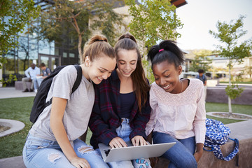 Female High School Students Using Digital Devices Outdoors During Recess