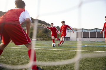 Group Of Male High School Students Playing In Soccer Team © Monkey Business