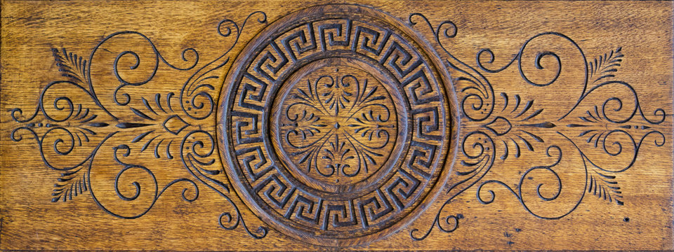 Old worn wooden carved decorative panel, may be used as background