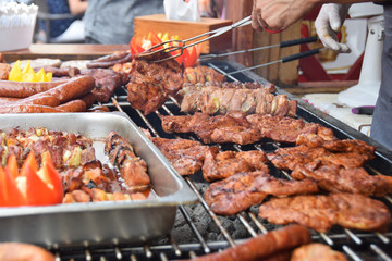 sausage steaks skewers grilled at festivity with peppers