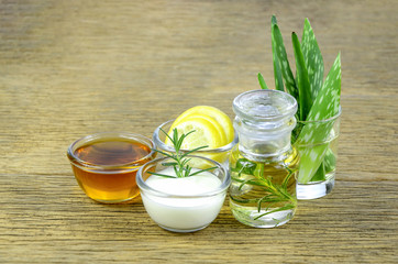 Honey, lemon, rosemary leaves, greek yogurt, aloe vera leaves and essential oil for homeopathy remedy.